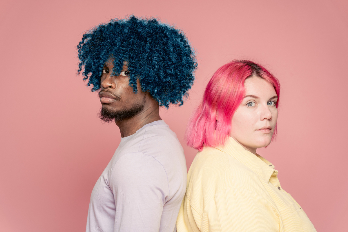 Serious diverse couple with dyed bright hair